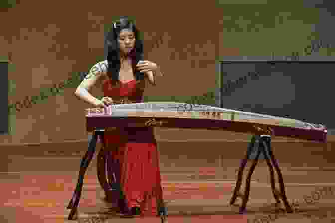A Woman Playing The Guzheng, A Traditional Chinese Zither How To Play Guzheng The Chinese Zither: The Basic Skills