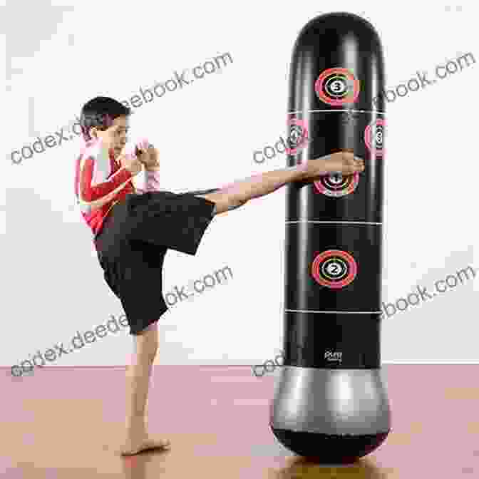 A Young Girl Practices Martial Arts, Punching A Punching Bag With Determination. Becoming A Girl: With Martial Arts